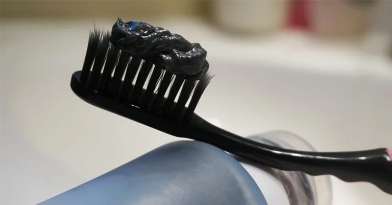 black toothpaste on brush